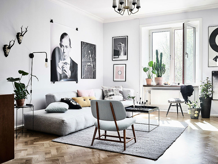 Scandinavian living room with different textiles layering with rugs, throw pillows, and throw blanket