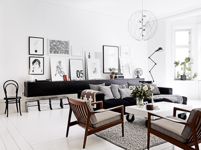 bright Scandinavian living room with lots of natural light and a mix of black and white furniture pieces