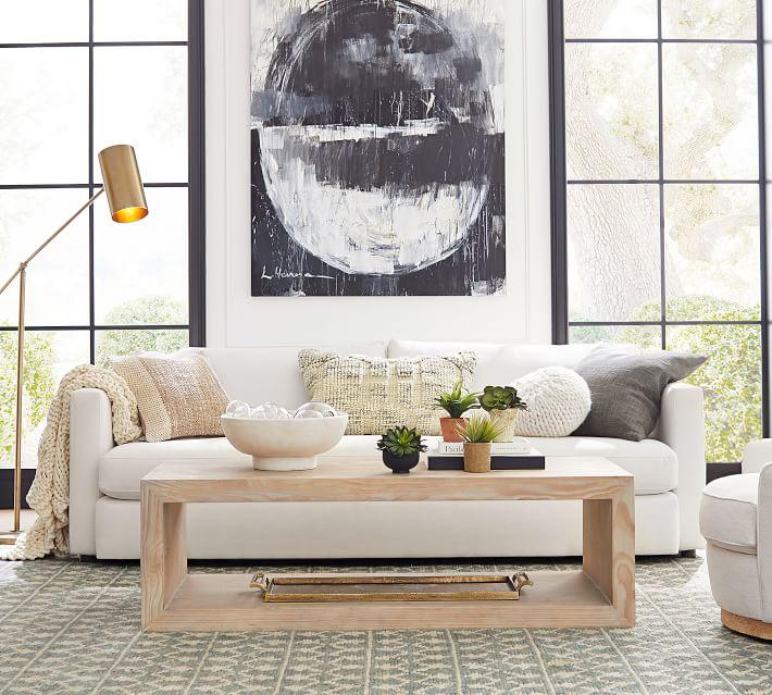 a traditional coffee table styled in with a group of 7 objects using the 3-5-7 design rule