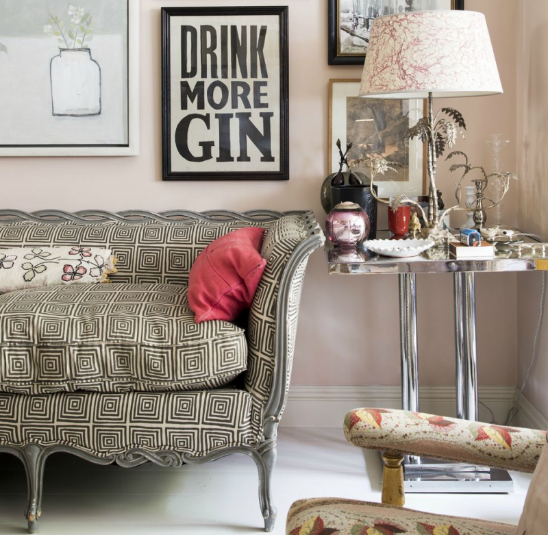 small feminine living room with plush wall color and a pattern sofa for a touch of pattern and styhle