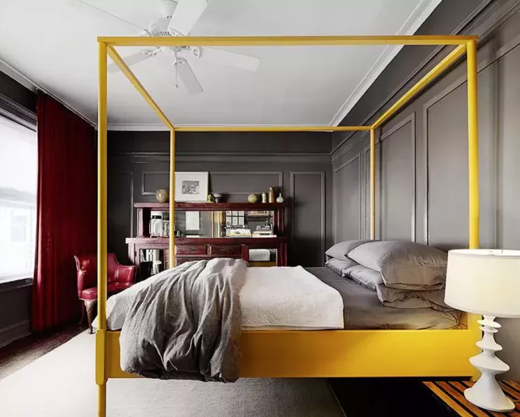 bold modern bedroom with a yellow conapy bed as the focal point.