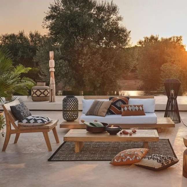 boho-patio-with-colorful-floor-throw-cushions-in-a-sunset