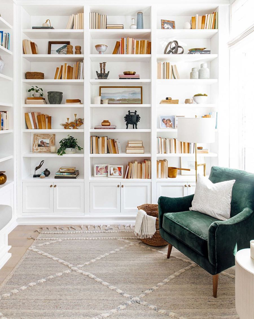 built-in-bookcases-with-green-velvet-chair-for-a-cozy-reading-nook