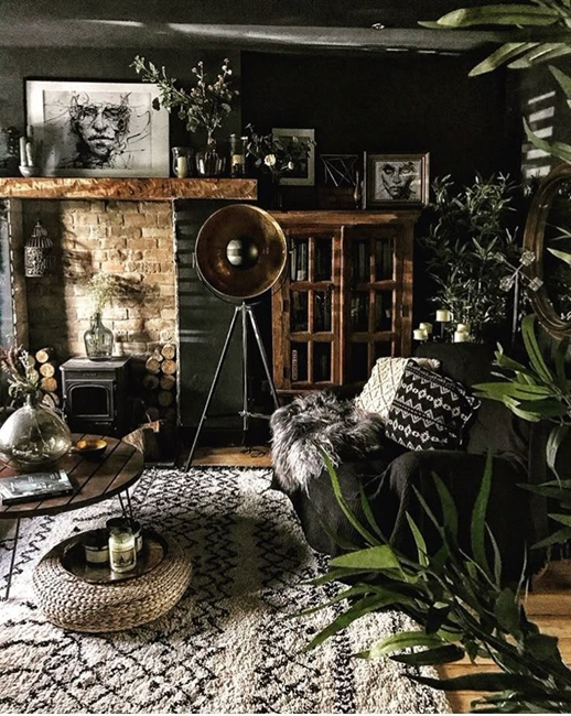 Moody bohemian living room full of palnts and dark wall color