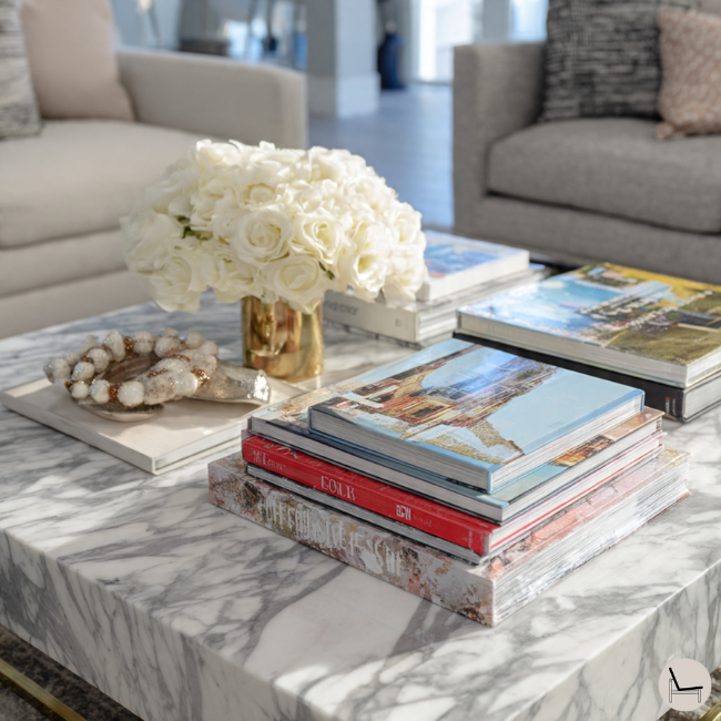 styling square marble coffee table with coffee table books and other accessories