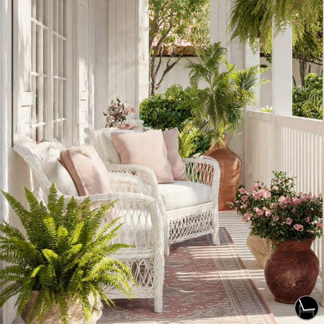 Small porch decorating with white chairs and vibrant textures and soft pillows