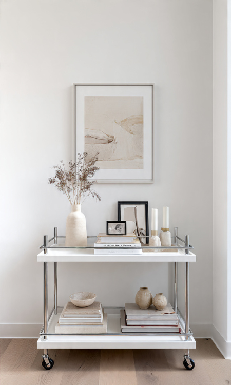 Bar cart styled as art and books display with sculptural objects